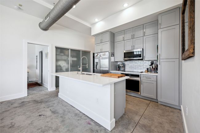 The fully updated kitchen includes all-new counters, cabinets, stainless steel appliances, an induction cooktop, and a built-in air fryer oven | Image 9