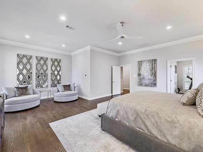 Bedroom with wood finished floors, ornamental molding, recessed lighting, and a ceiling fan | Image 20
