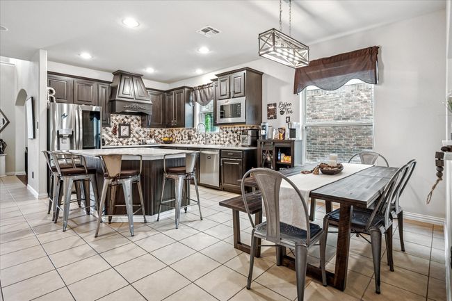 Dining space with light tile patterned flooring, recessed lighting, and baseboards | Image 10