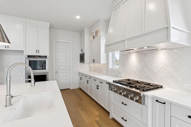 Offering outstanding storage and prep space paired with high end appliances, any chef would be proud to call this dream kitchen their own! | Image 9
