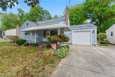 View of front of house with a porch and a garage | Image 1