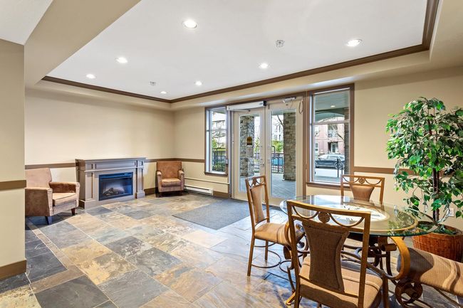 Building entrance featuring fireplace, easy care slate flooring. Building also features a furnished guest suite and meeting room with large exterior patio for extra large gatherings. | Image 37