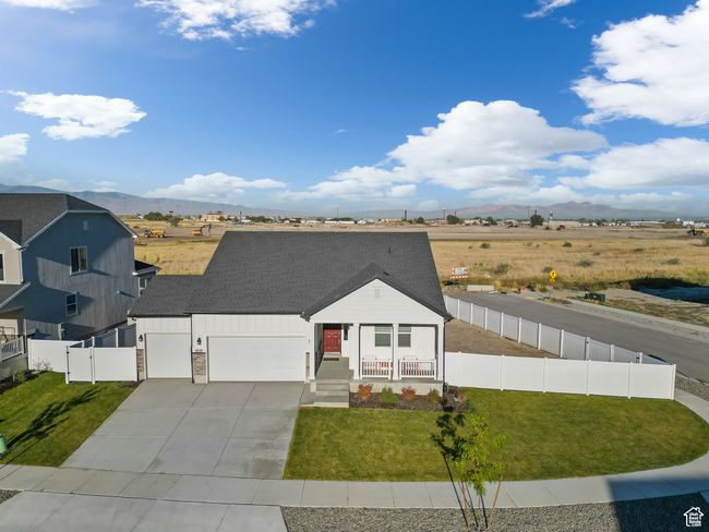 View of front of house featuring covered porch, fence, a mountain view, and a front lawn | Image 30