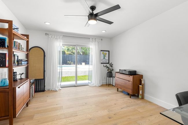 Home office with light wood-type flooring, baseboards, a ceiling fan, and recessed lighting | Image 18