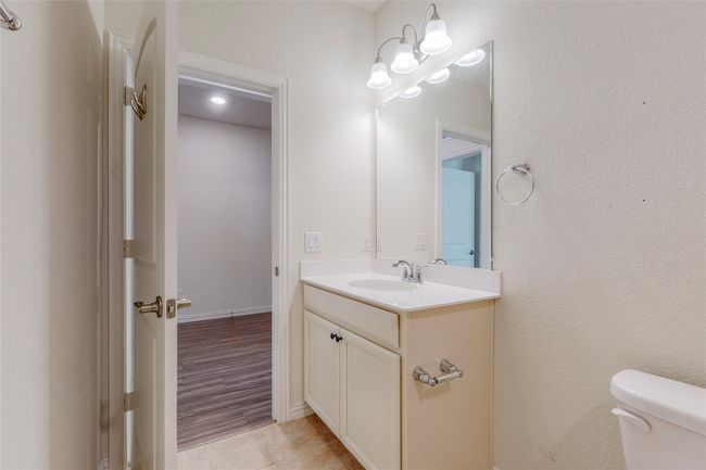 Half bathroom featuring vanity and toilet | Image 13