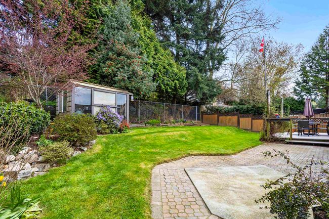 View of yard featuring a fenced backyard, an outdoor structure, and a patio | Image 27