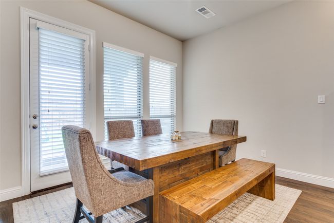 Dining space with baseboards and wood finished floors | Image 11