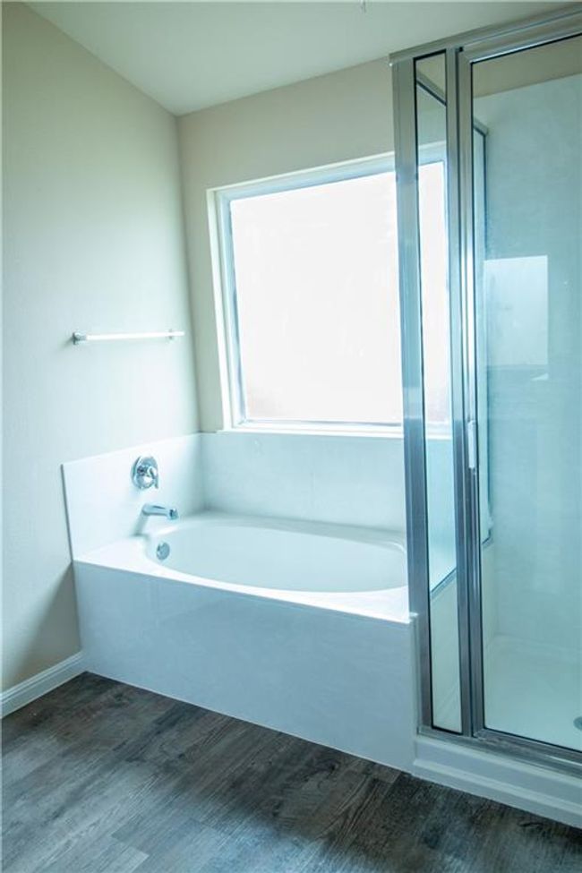 Full bathroom with wood finished floors, a garden tub, and a shower stall | Image 9