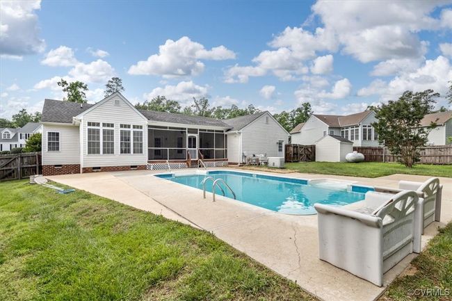View of swimming pool with a sunroom, a patio area, a storage shed, and an outdoor structure | Image 48