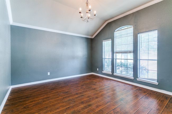 The dining room has three windows that bring in lots of natural light. | Image 7