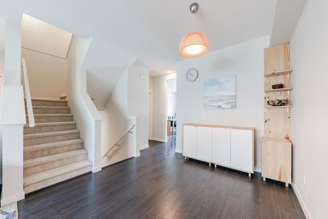 Empty room featuring dark wood-type flooring and stairway | Image 4