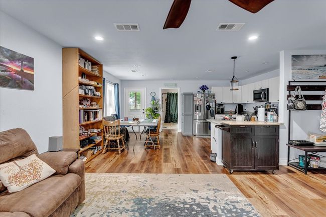 Living area featuring light wood-style floors, recessed lighting, and a ceiling fan | Image 6