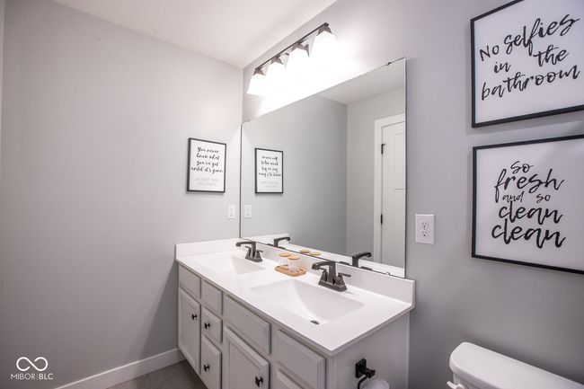 bathroom featuring double vanity and toilet | Image 23