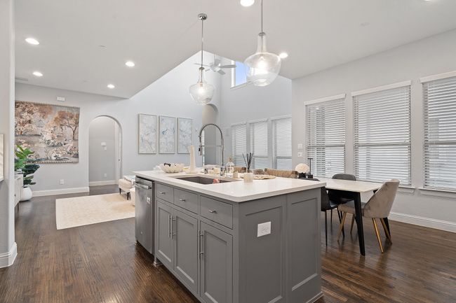 Kitchen with gray cabinetry, recessed lighting, light countertops, decorative light fixtures, and dark wood finished floors | Image 8