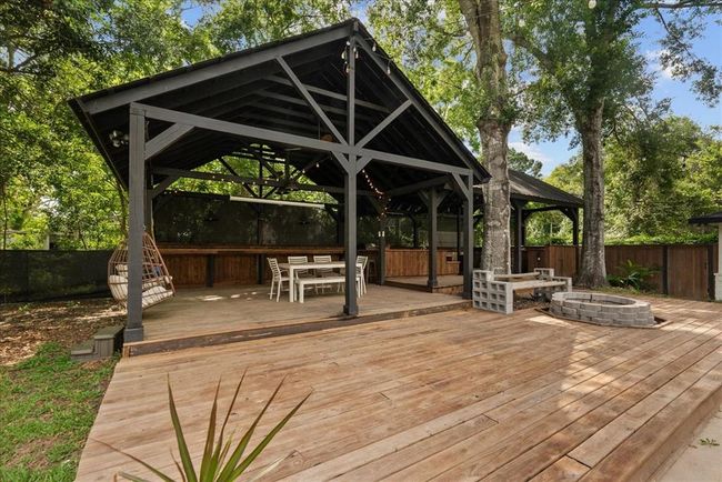 Dreamy outdoor living with covered pavilion, dining area, and cozy firepit—perfect for entertaining! | Image 10