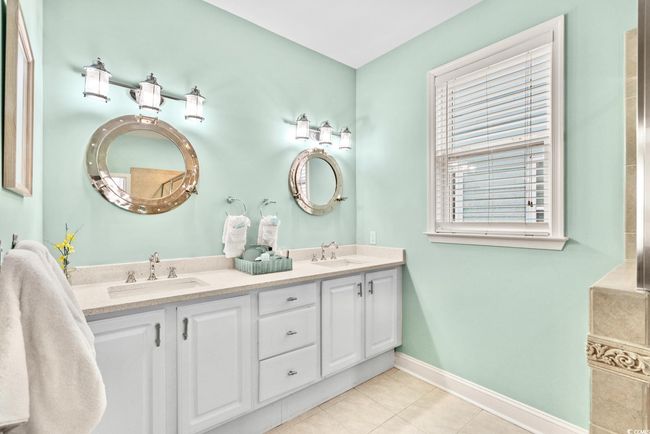 Full bathroom with a sink, tile patterned floors, baseboards, and double vanity | Image 14