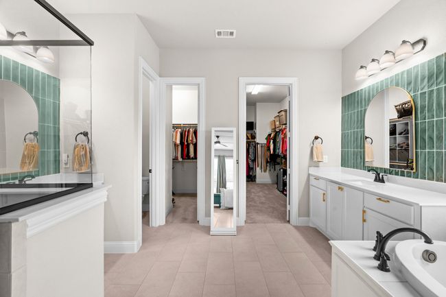 Bathroom featuring a walk in closet, vanity, a tub, and tile patterned floors | Image 22