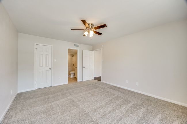 Unfurnished bedroom featuring ceiling fan, a closet, carpet floors, and ensuite bathroom | Image 22
