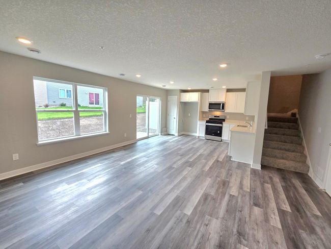 Beautiful living space with lots of windows bring in lots of natural light. Photo is of actual home. Colors and options may vary. Ask Sales Agent for details. | Image 20