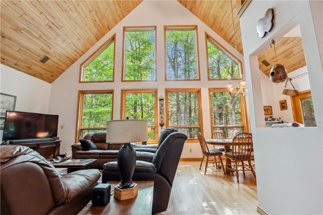 Living room with beautiful wood flooring and beautiful views to the river | Image 11