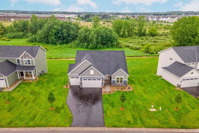 An aerial view showcasing the prime location backing up to a lush backdrop in a peaceful new community. | Image 4