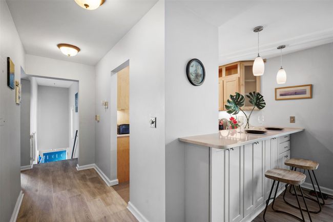 Corridor featuring an upstairs landing, wood finished floors, and baseboards | Image 5