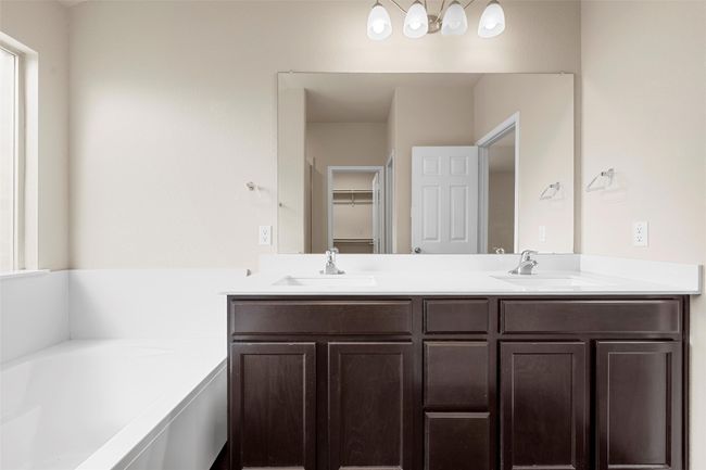 Full bathroom featuring double vanity and a bath | Image 21