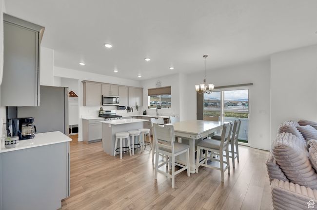 Dining space featuring recessed lighting, a notable chandelier, and light wood finished floors | Image 4