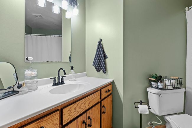 The upper level bathroom has a spacious vanity for ample storage underneath. | Image 14