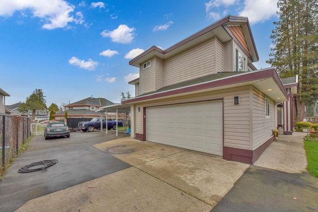 View of property exterior featuring a garage and driveway | Image 4