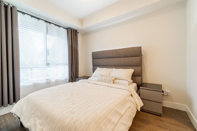 Bedroom with baseboards, wood finished floors, and multiple windows | Image 18