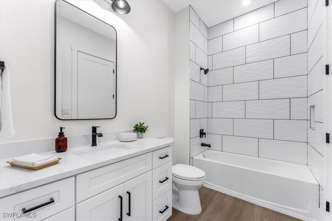 Full bath with vanity, wood finished floors, and shower combination | Image 17