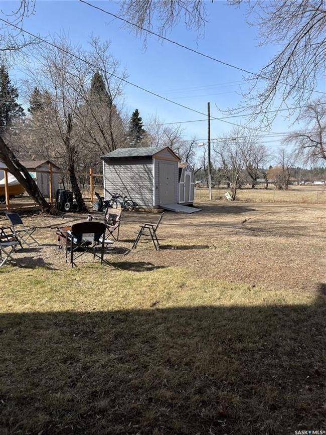 View of yard featuring a storage unit and an outdoor structure | Image 8