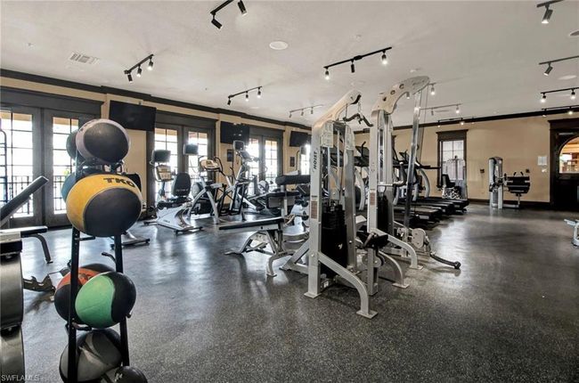 Workout area featuring french doors | Image 48