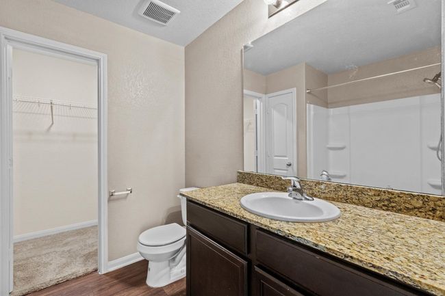 Full bath featuring visible vents, wood finished floors, toilet, and vanity | Image 13