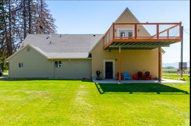 Back of property featuring a wooden deck, a yard, and a patio area | Image 4