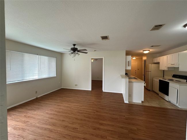 Kitchen featuring electric range, freestanding refrigerator, light countertops, and a ceiling fan | Image 4