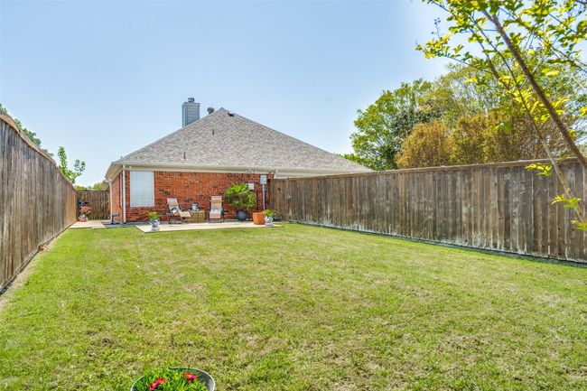 The level, fenced backyard provides a nice grassy area for kids, pets or friends to enjoy. | Image 24
