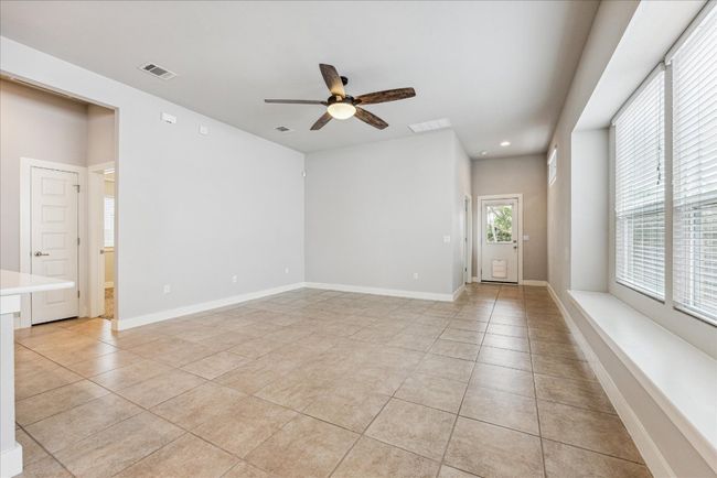 Empty room with light tile patterned flooring, ceiling fan, recessed lighting, and baseboards | Image 9