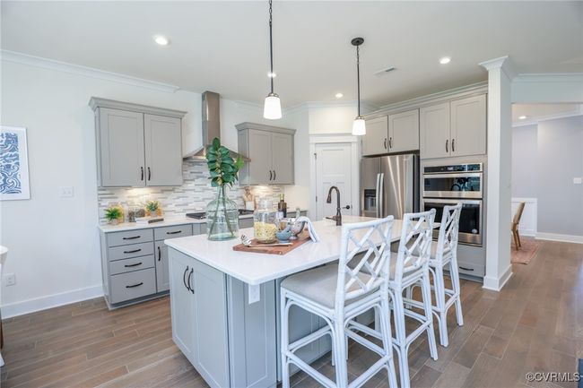 Kitchen with granite countertops, gas cooking, island, pantry, stainless steel appliances and LED recessed lighting. | Image 5
