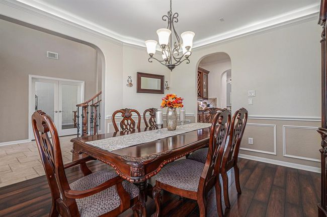 Imagine family meals during the holidays or late-night evening card games with the neighbors in this formal dining space! | Image 17