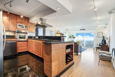 Kitchen open to living room. | Image 1