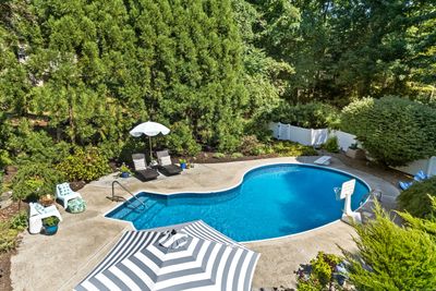 fenced in pool area with mature plantings and plenty of seating areas | Image 2