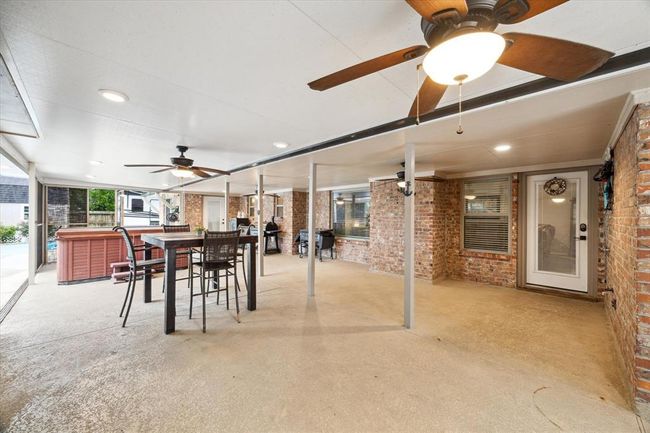 Screened covered Patio w/lighting, ceiling fans and hot tub | Image 22