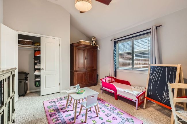 Bedroom featuring carpet floors, vaulted ceiling, a closet, and a ceiling fan | Image 16