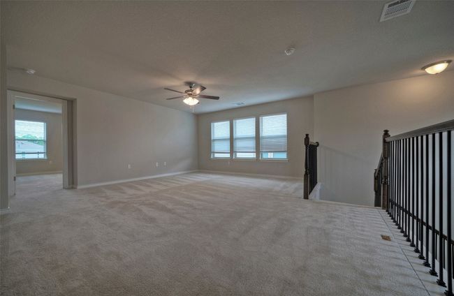 Empty room with a ceiling fan, light carpet, baseboards, and visible​​‌​​​​‌​​‌‌​‌‌​​​‌‌​​‌‌​‌​​​​​‌ vents | Image 17