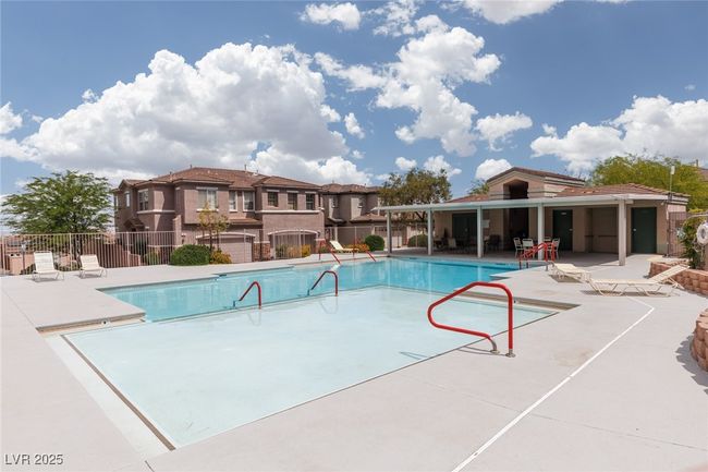 Community pool with fence and a patio area | Image 29