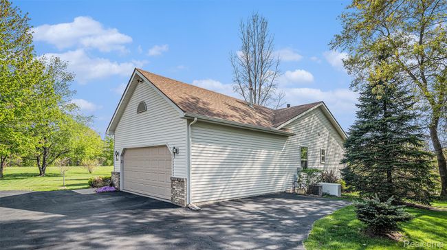 2 car garage, paved side pad for extra parking, & whole house generator | Image 32