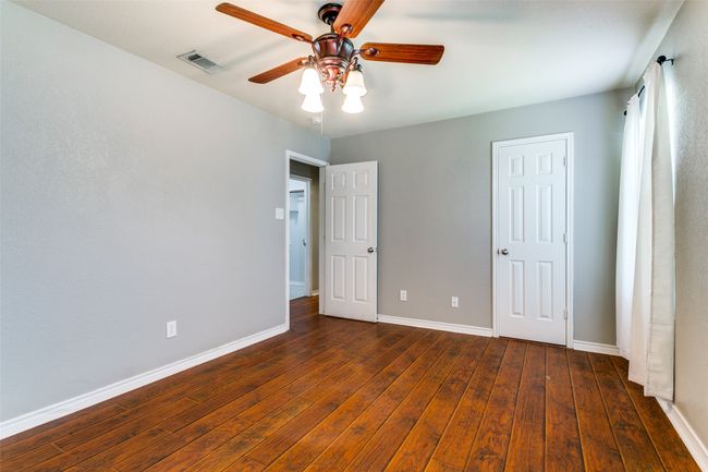 The second bedroom has two windows, a ceiling fan, walk-in closet and no carpet!!!! | Image 25