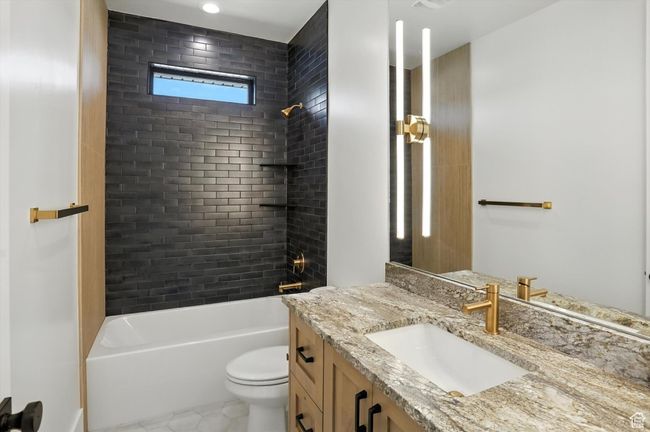 Full bathroom featuring vanity, shower / bath combination, and tile patterned flooring | Image 21